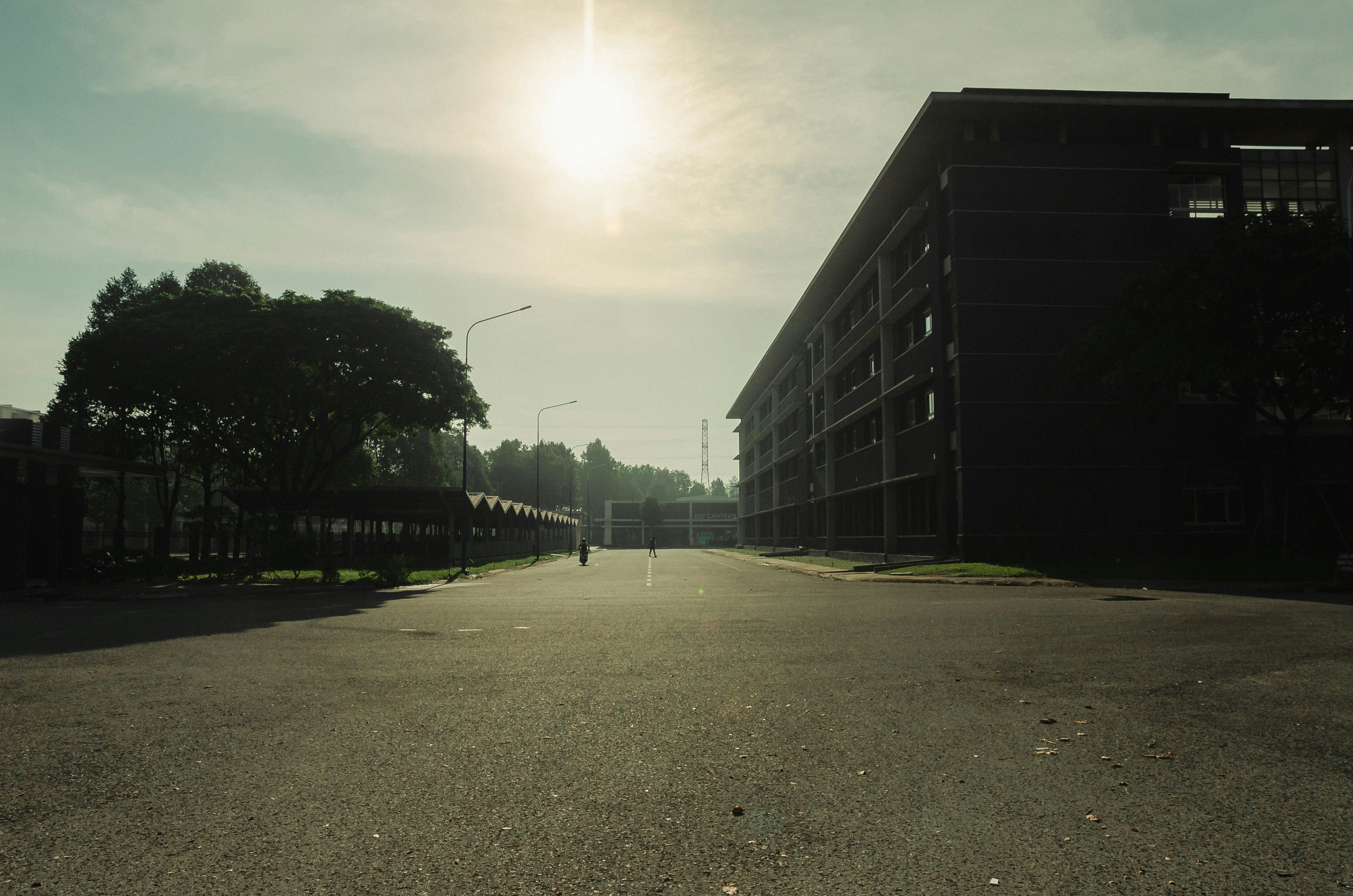 a person walking down a street in front of a building