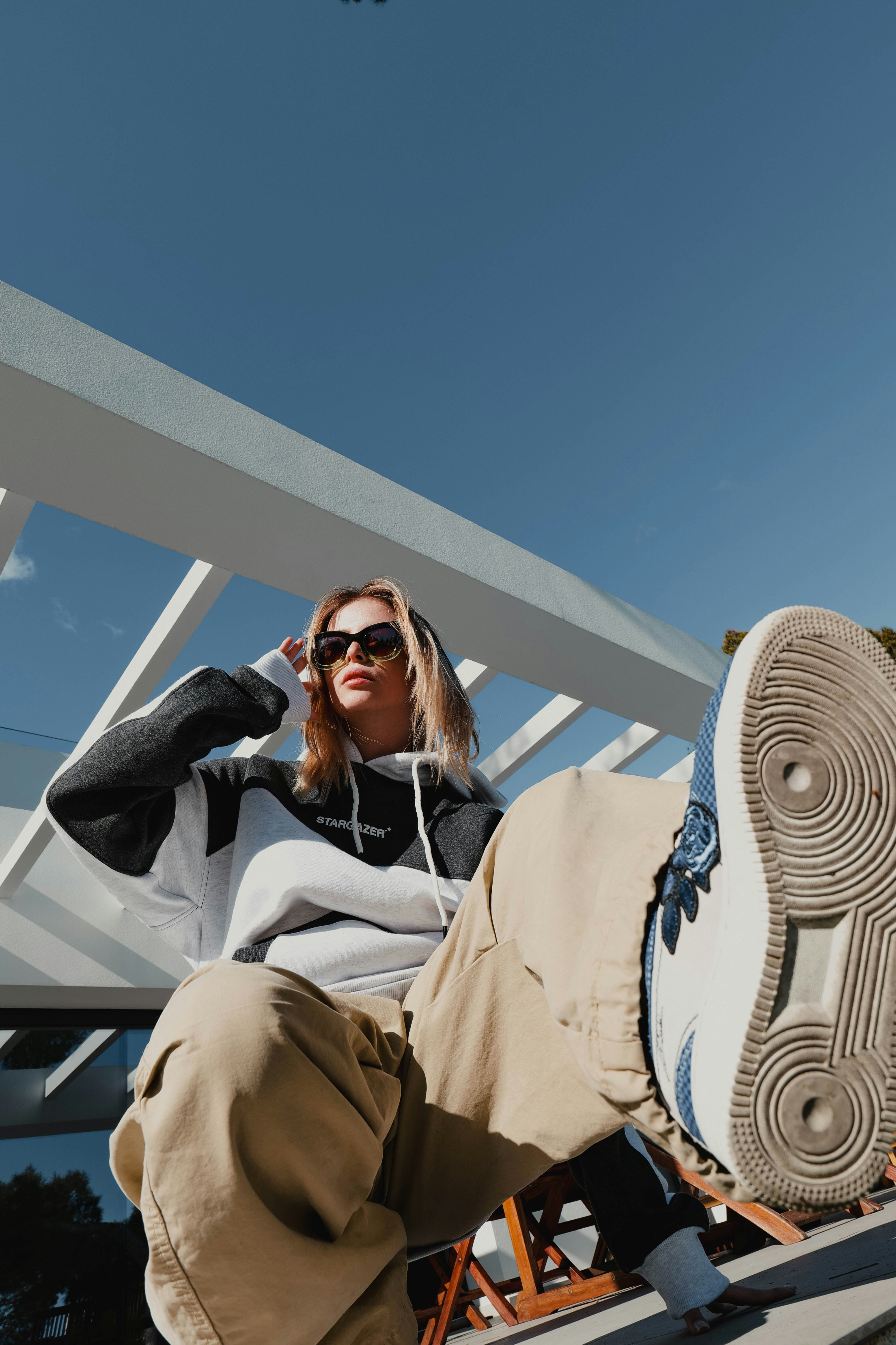 a woman sitting on a bench with a pair of shoes