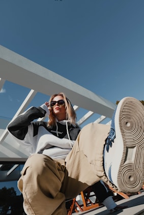a woman sitting on a bench with a pair of shoes