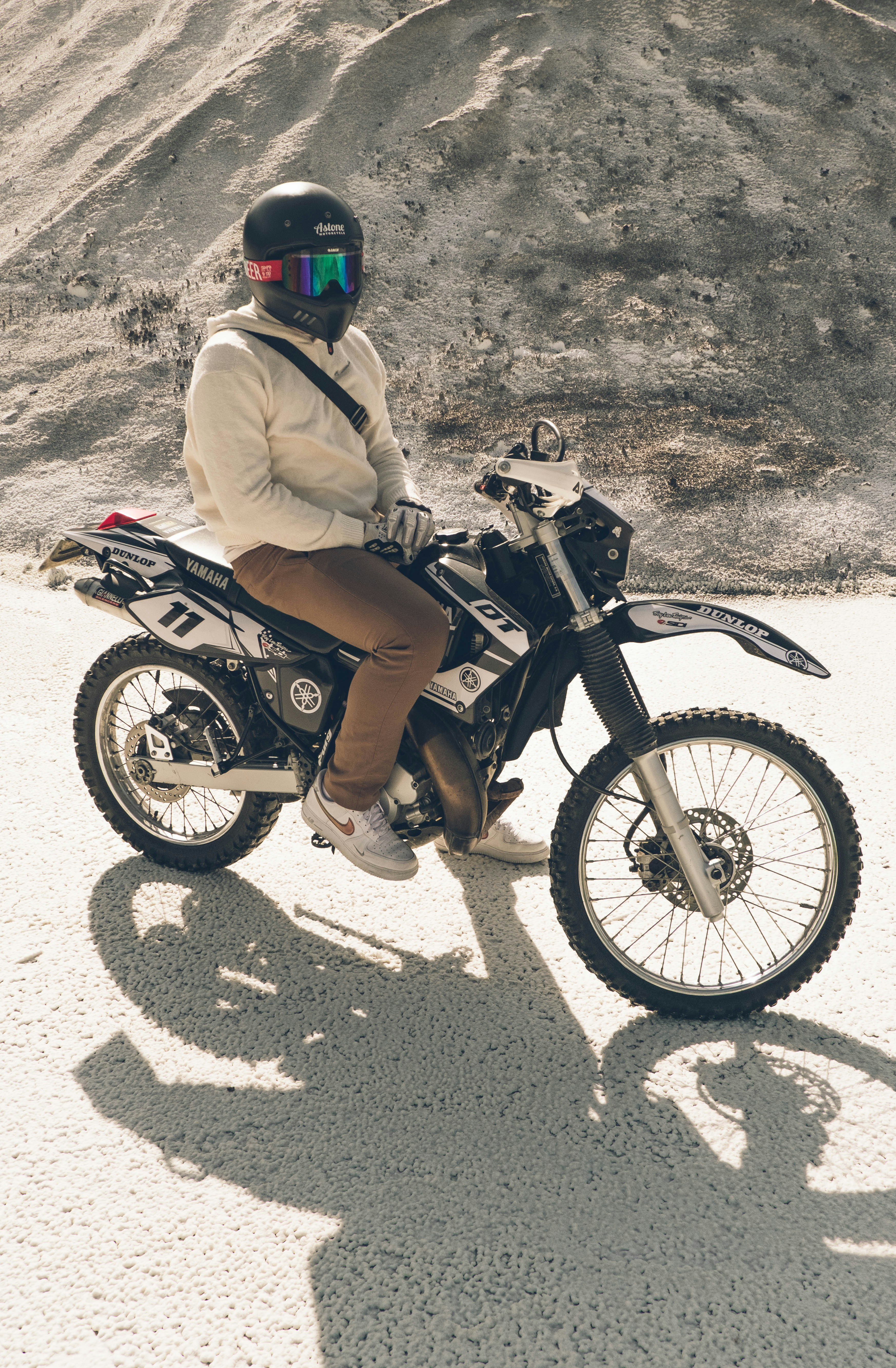 a person riding a motorcycle on a dirt road
