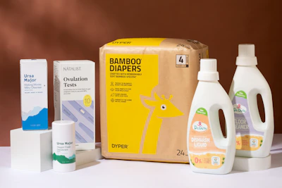 a box of diapers next to a bottle of lotion