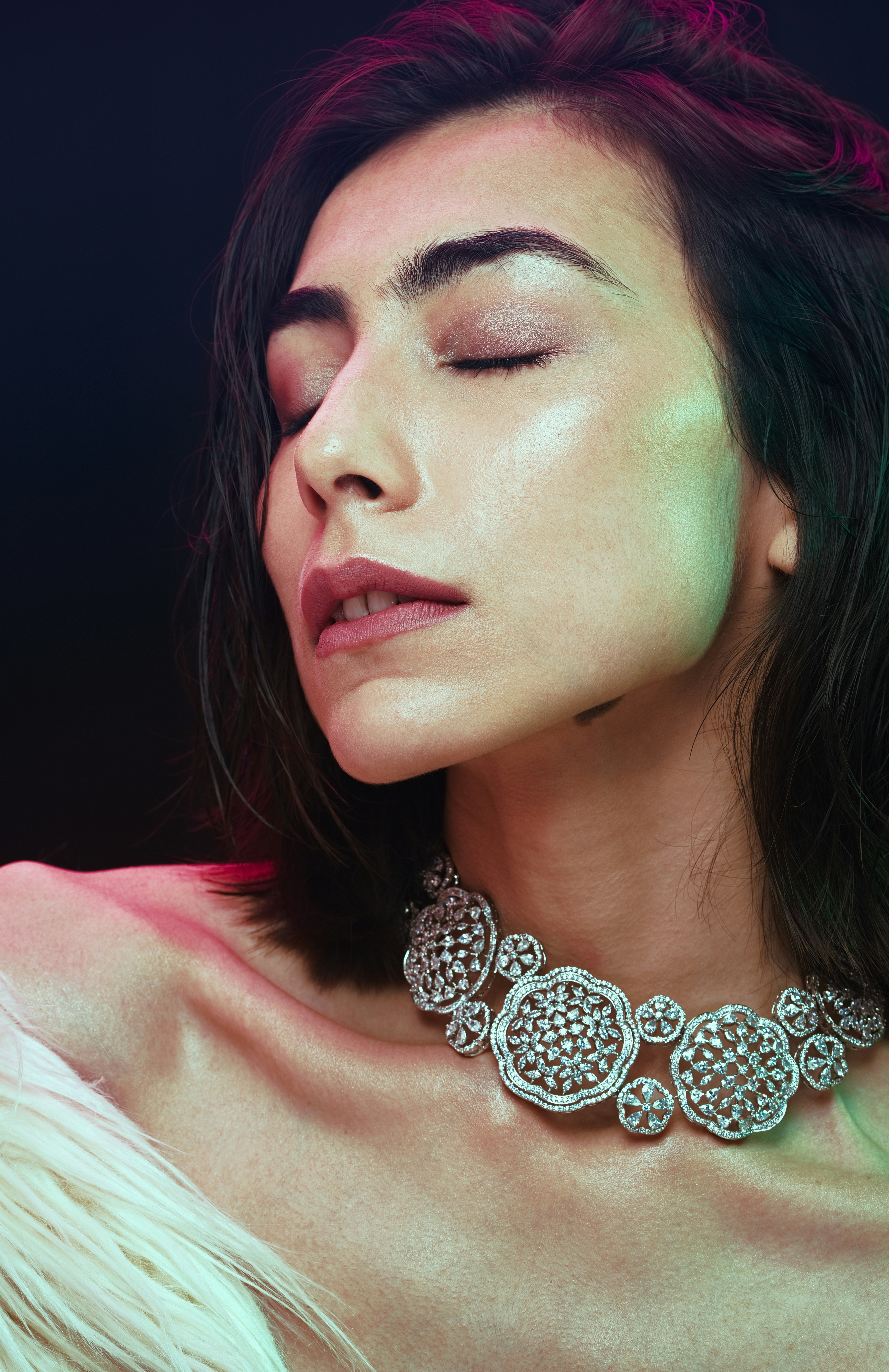 a woman in a white dress wearing a necklace