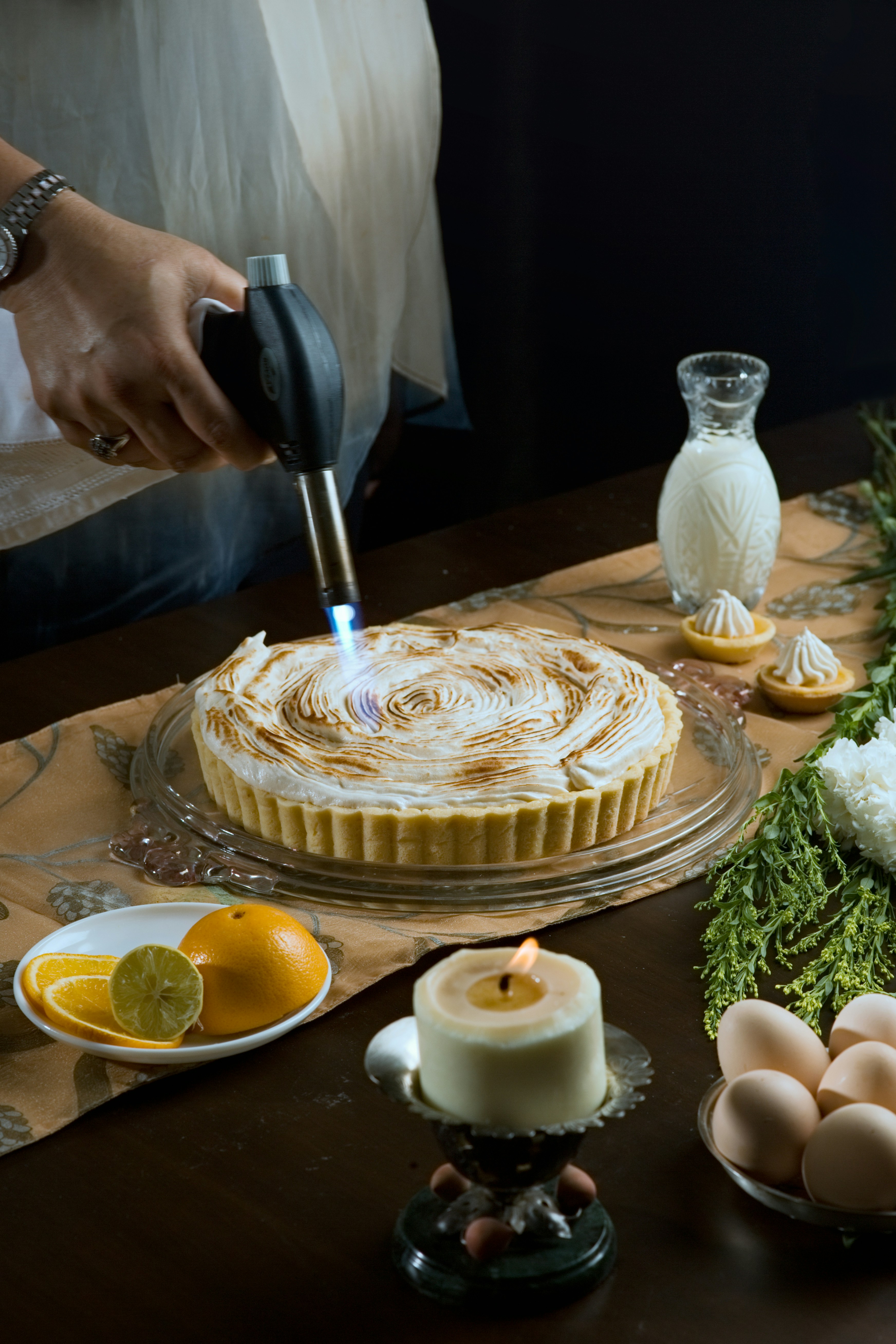a person cutting a cake with a knife