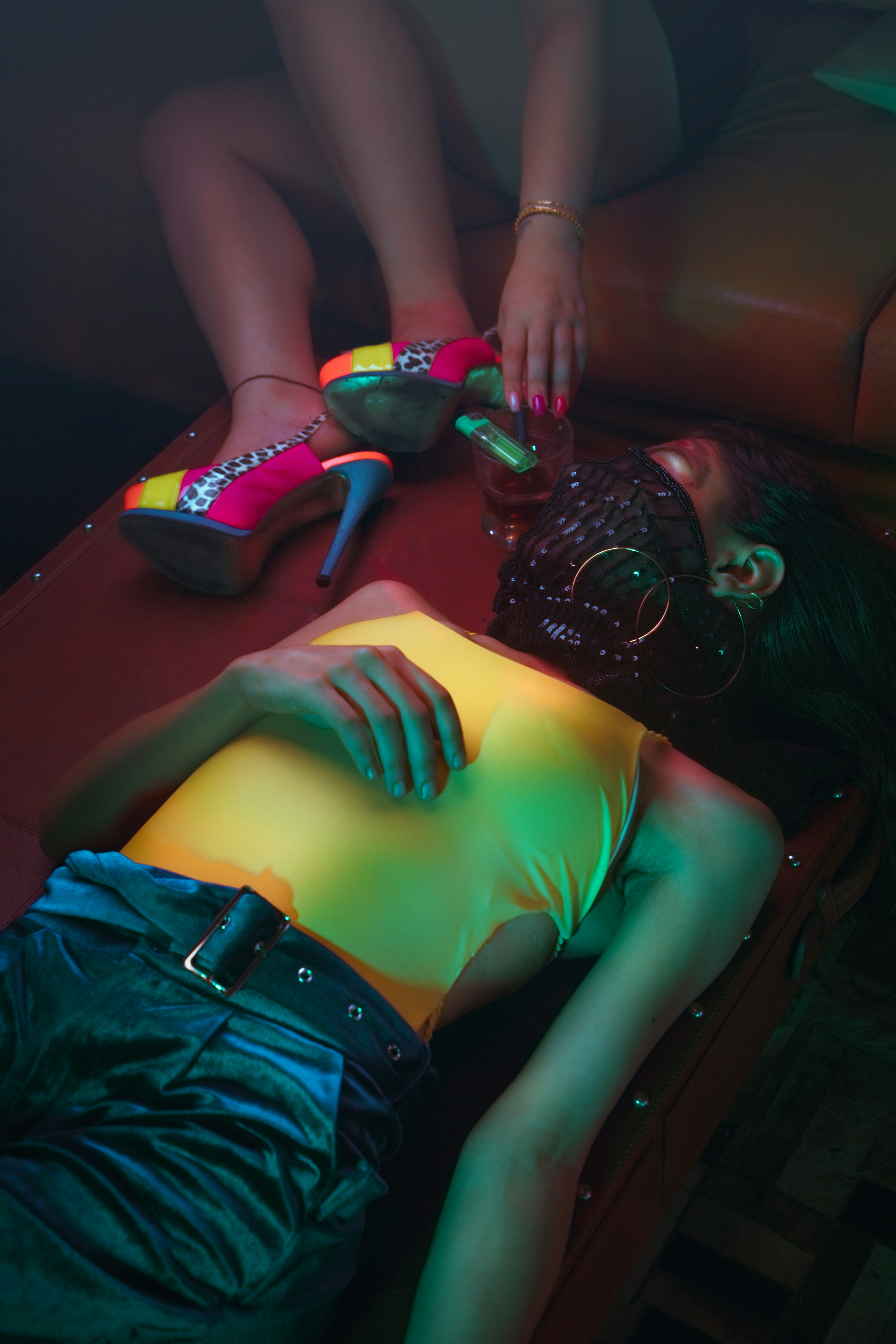 a woman laying on a couch next to a table