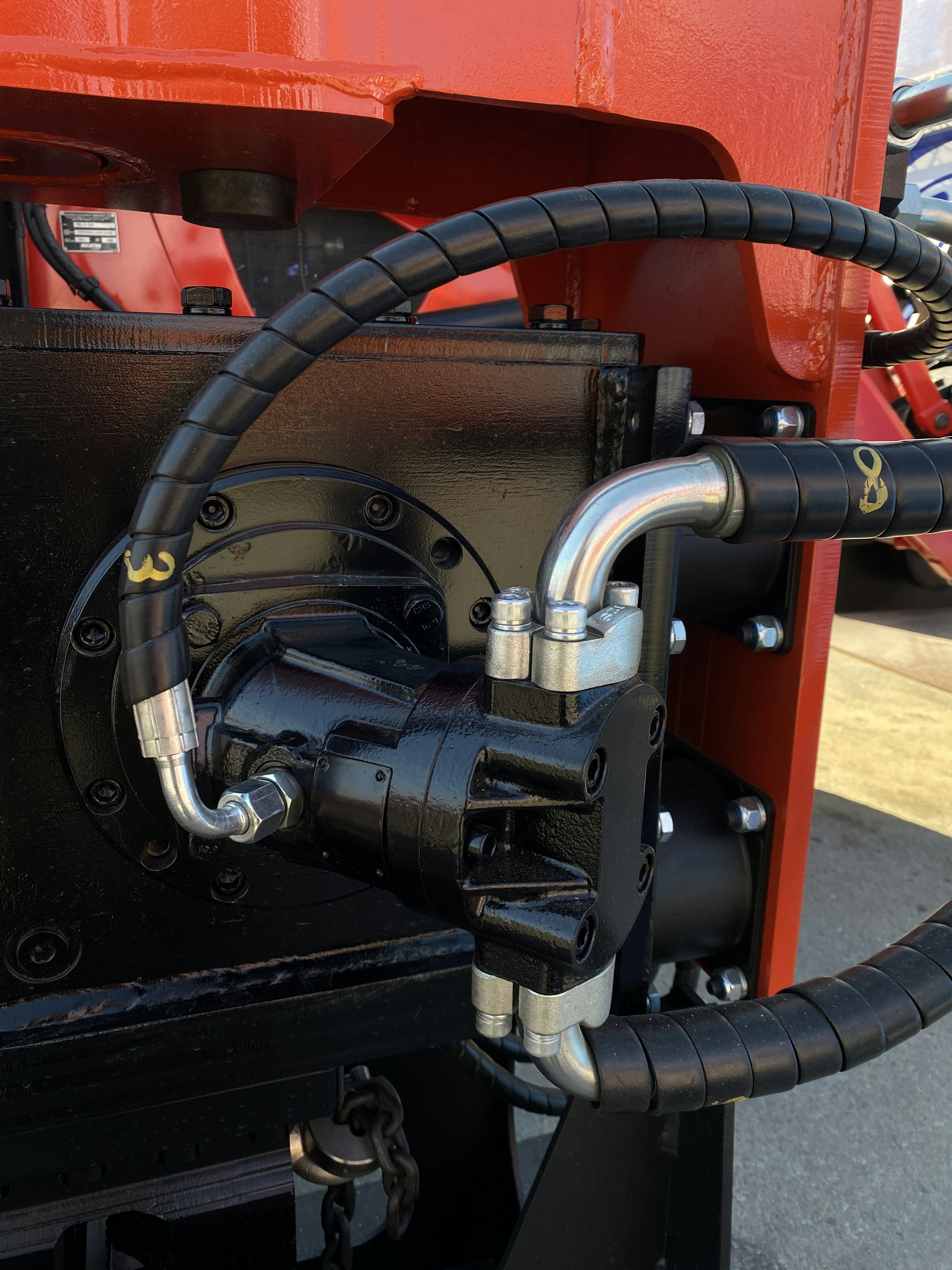 Correct hydraulic hose installation showing secured clamps