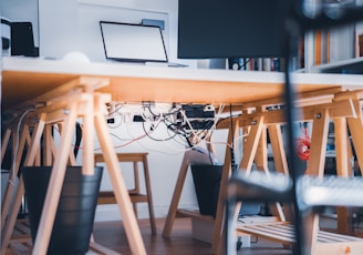 a desk with a laptop on top of it