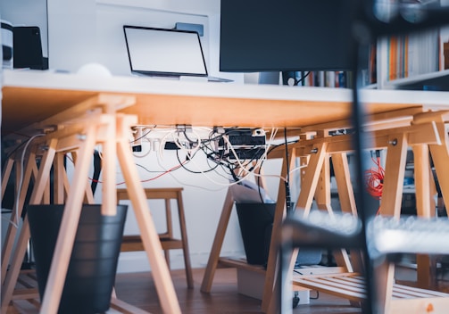 a desk with a laptop on top of it