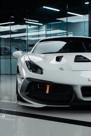 a white sports car parked in a garage