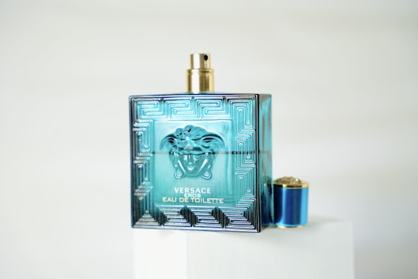 Versace Eros bottle displayed on white pedestal