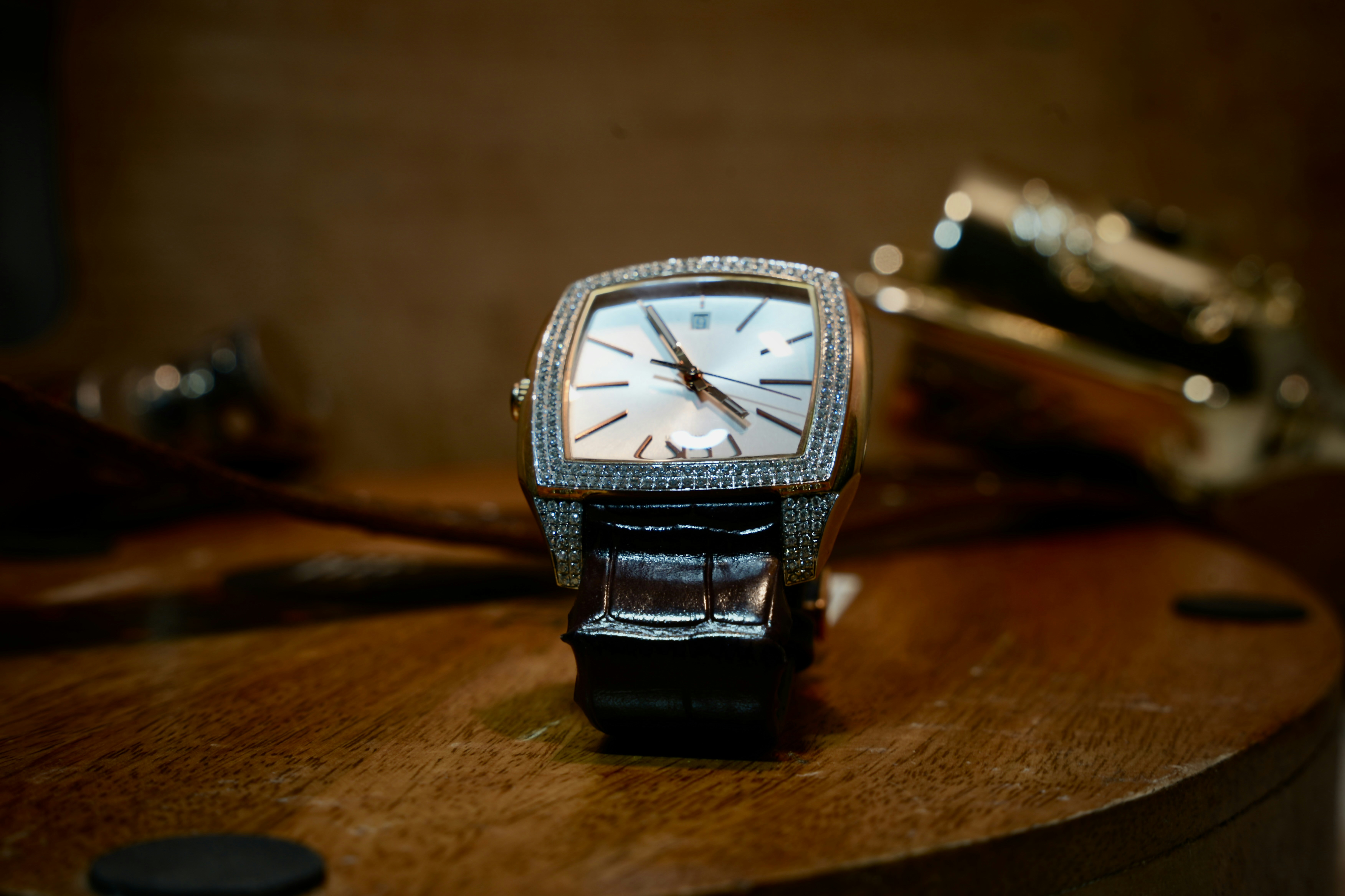 a watch sitting on top of a wooden table