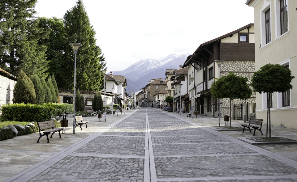 Cobblestone street lined with traditional stone houses in Bansko's old town