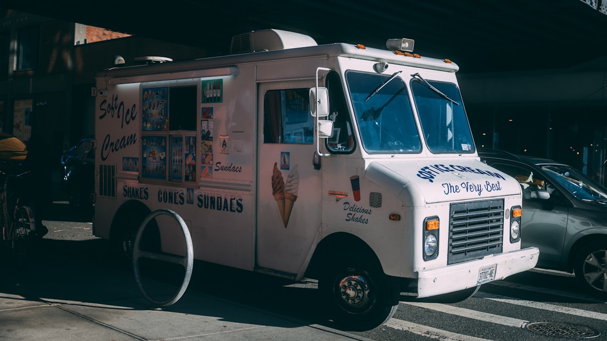 an ice cream truck parked on the side of the road