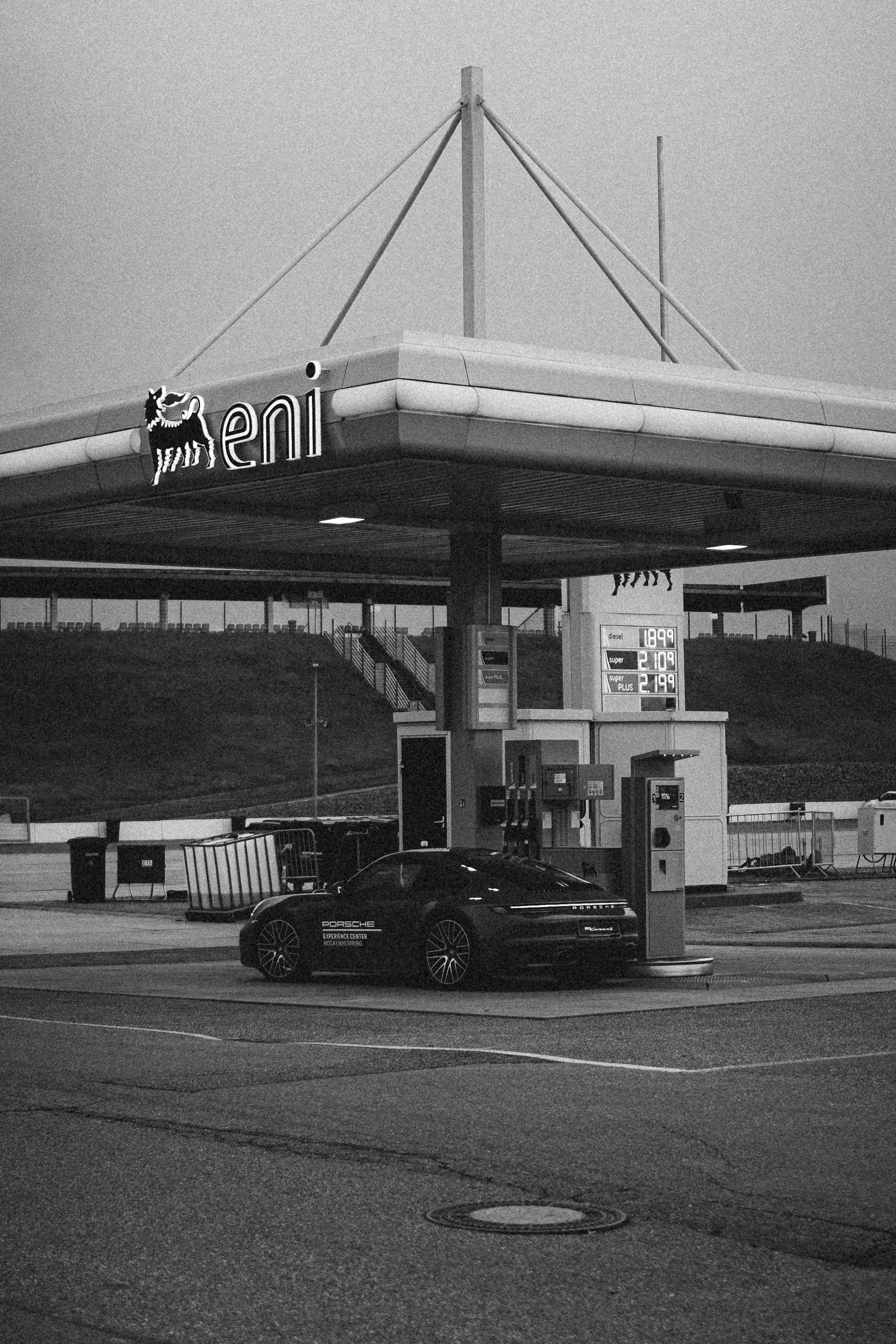 a black and white photo of a gas station