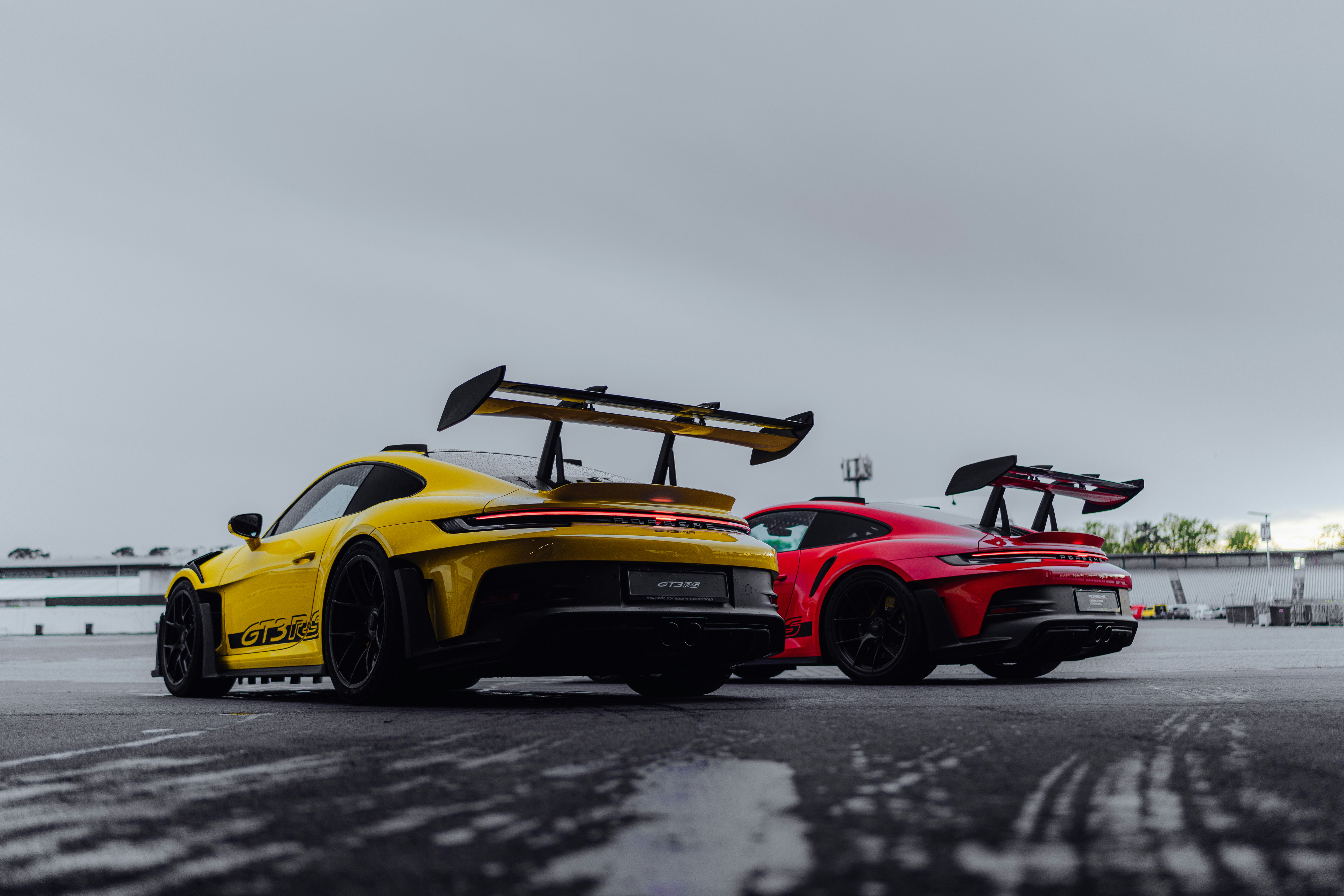 Two yellow and red sports cars parked next to each other photo – Free ...