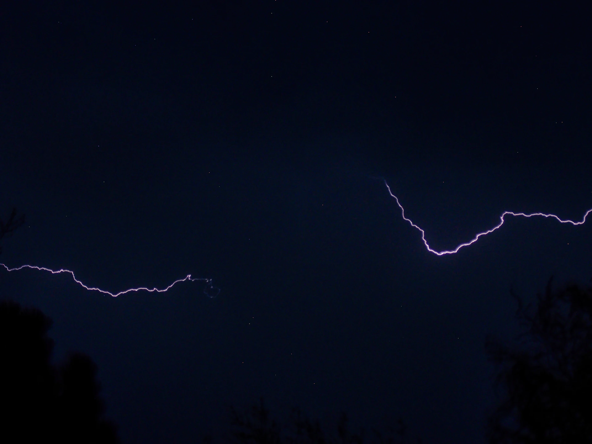 a couple of lightning strikes in the night sky