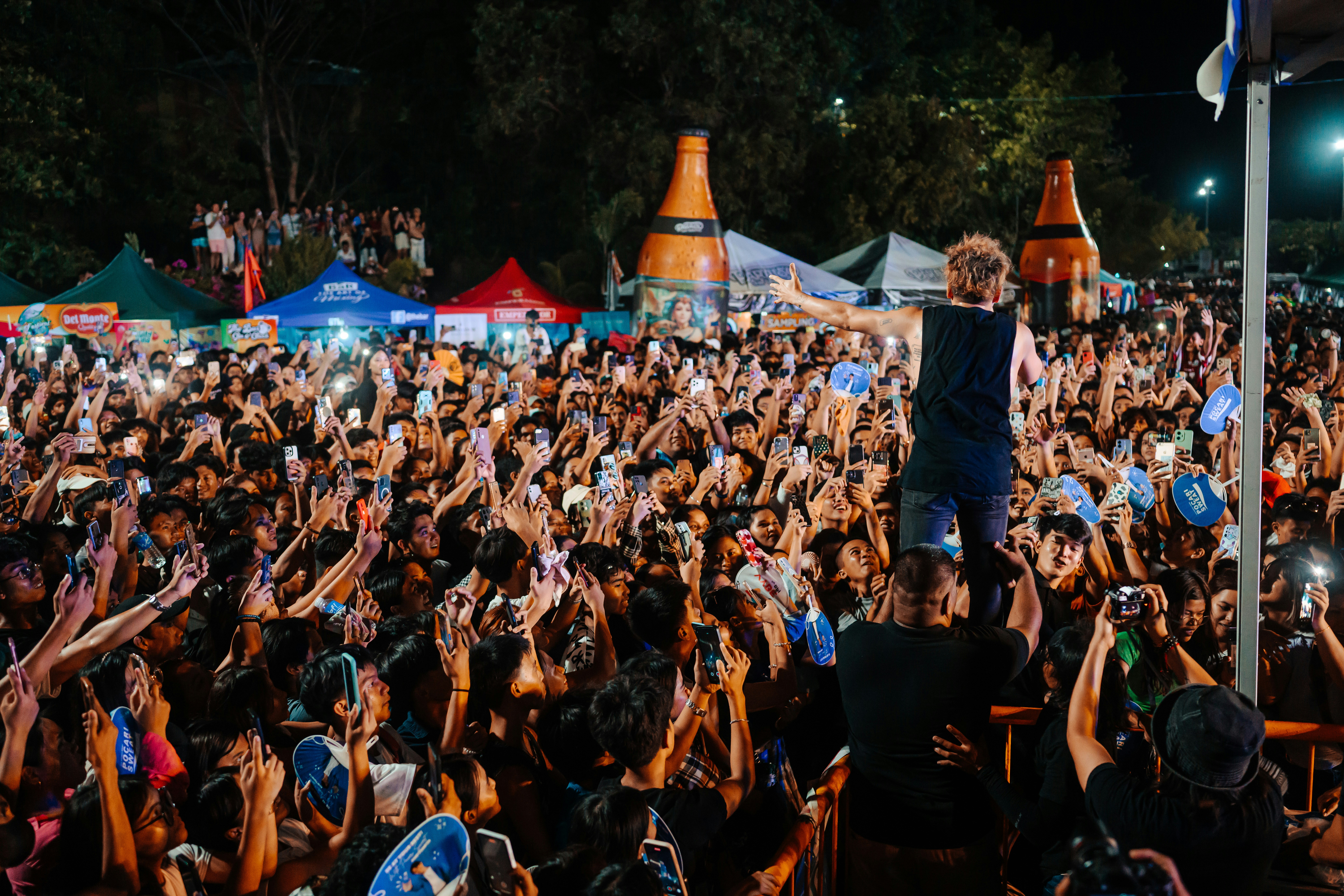 a man standing on top of a crowd of people