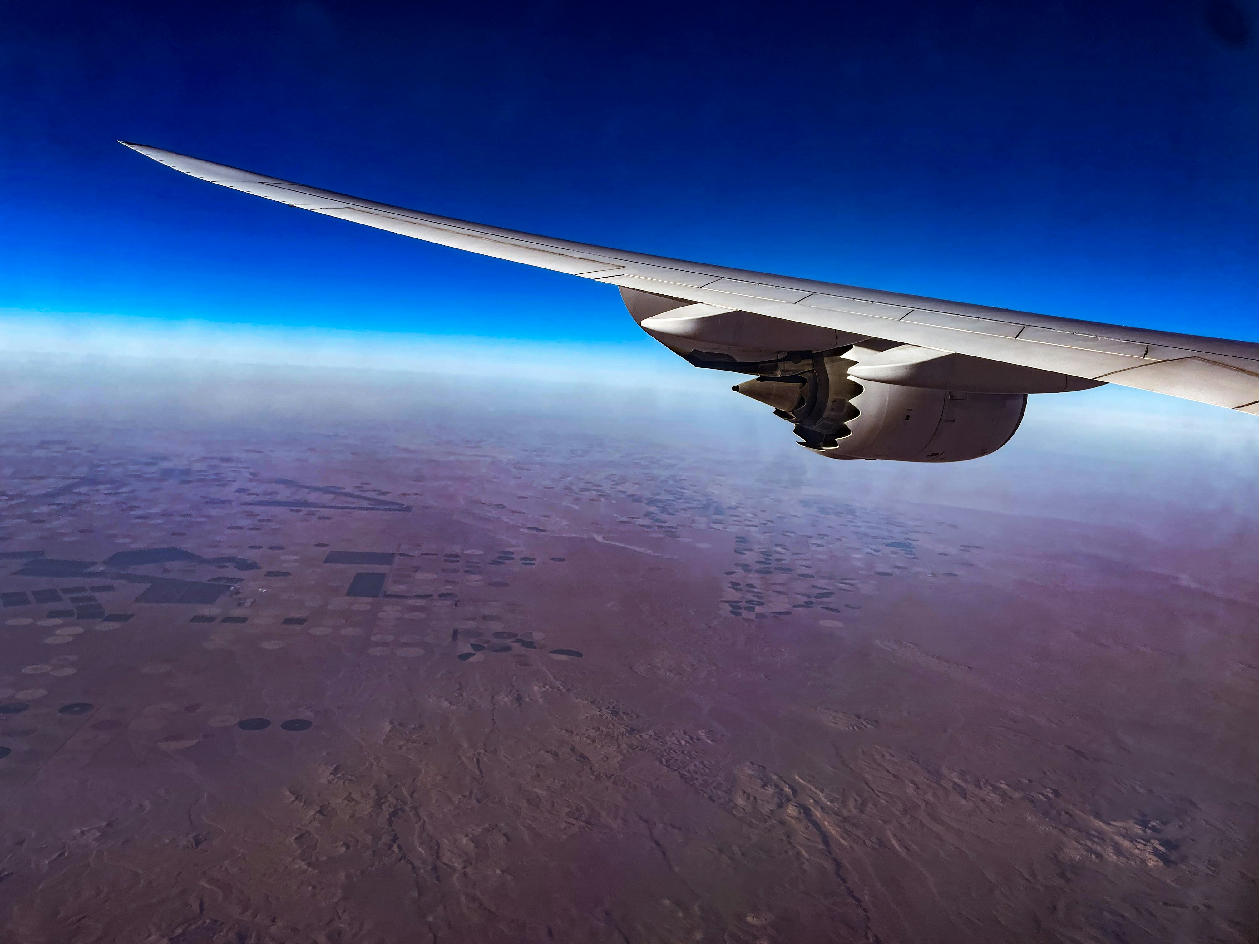 a view of the wing of an airplane in the sky