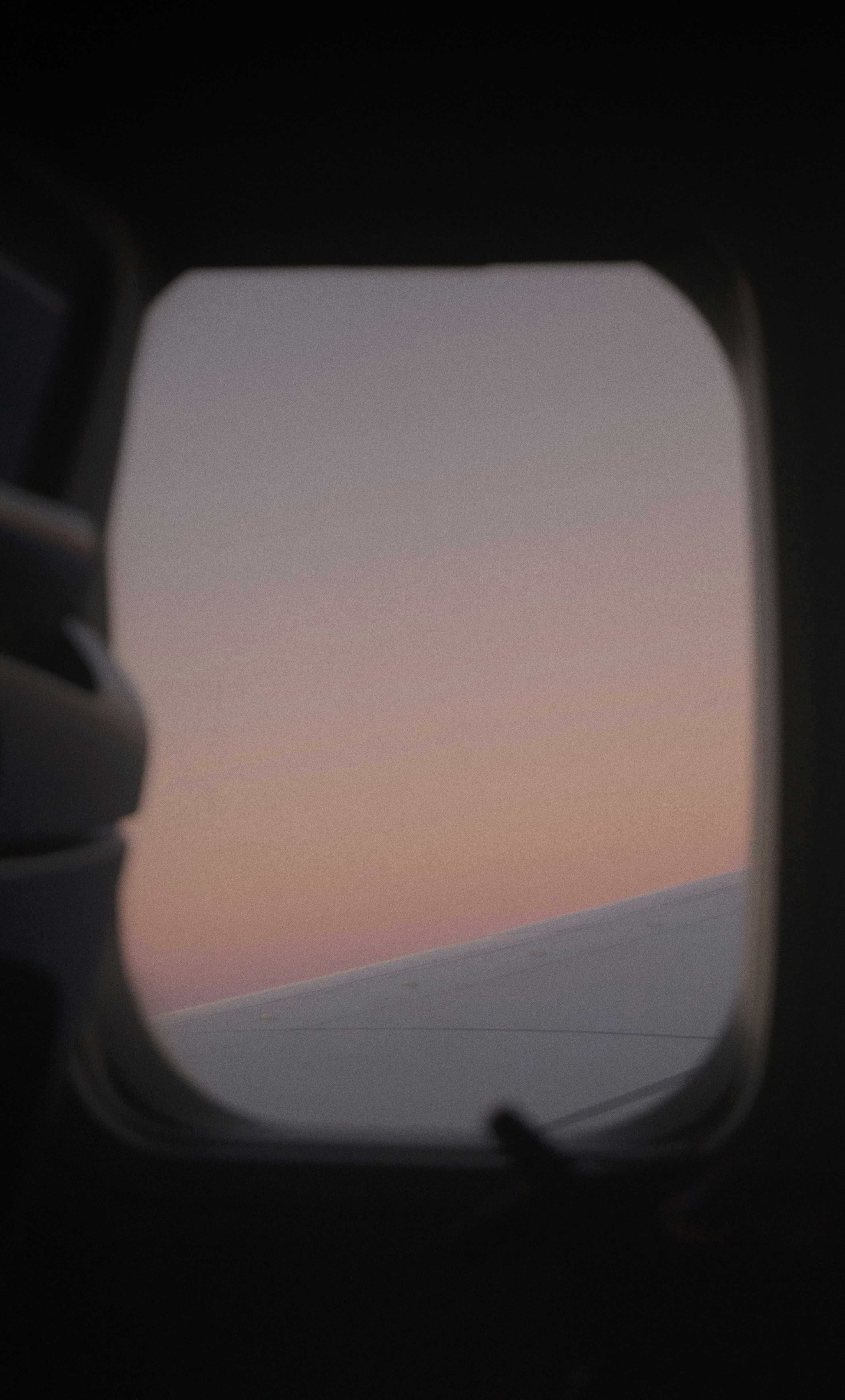 a view of the wing of an airplane at dusk