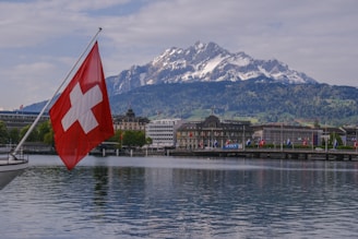 a swiss flag on a boat in the water