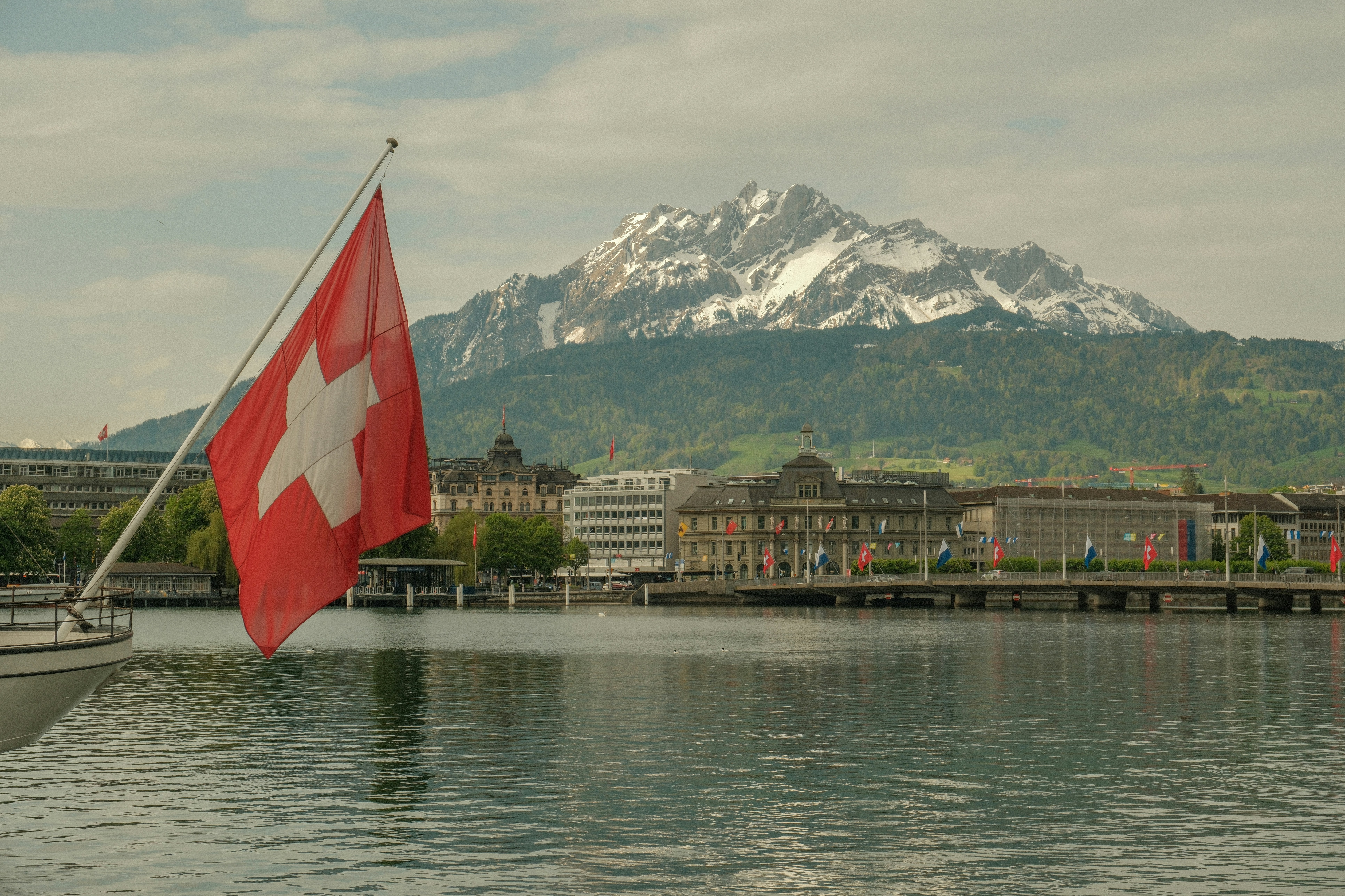 a swiss flag on a boat in the water