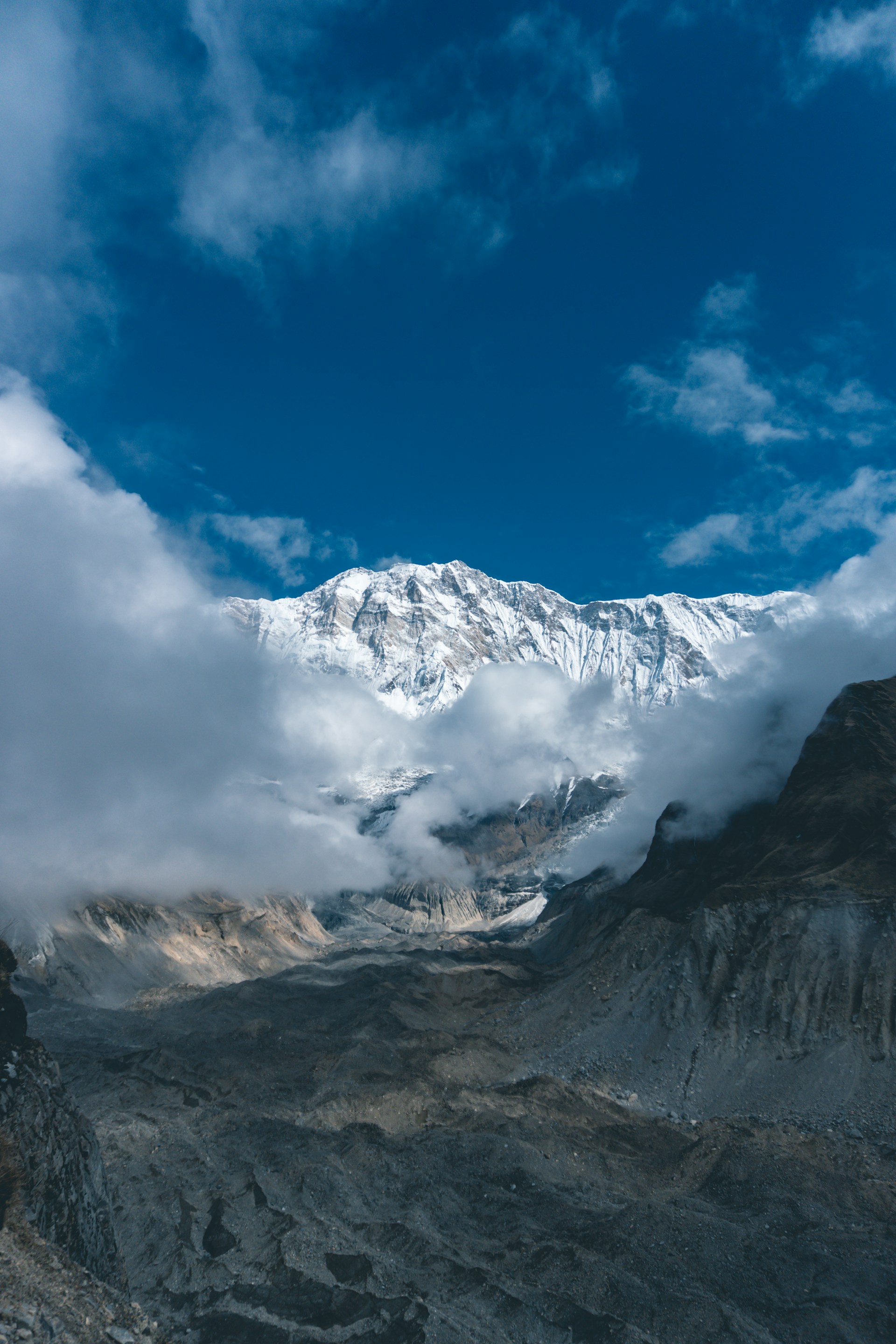 a view of a mountain range with clouds in the sky