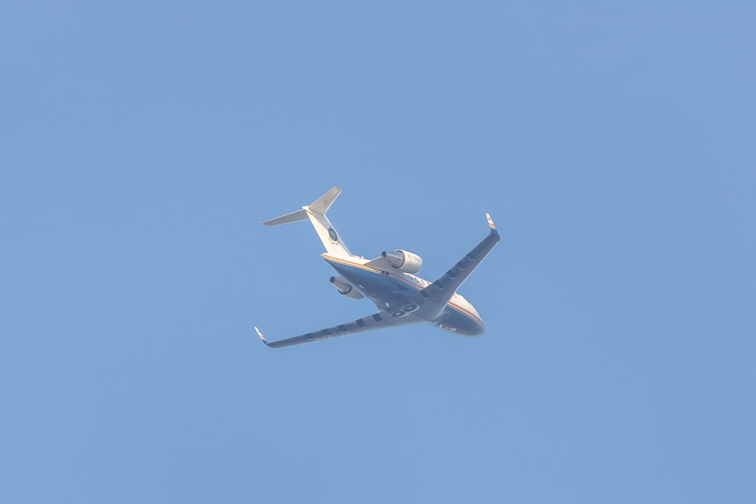 a large jetliner flying through a blue sky,