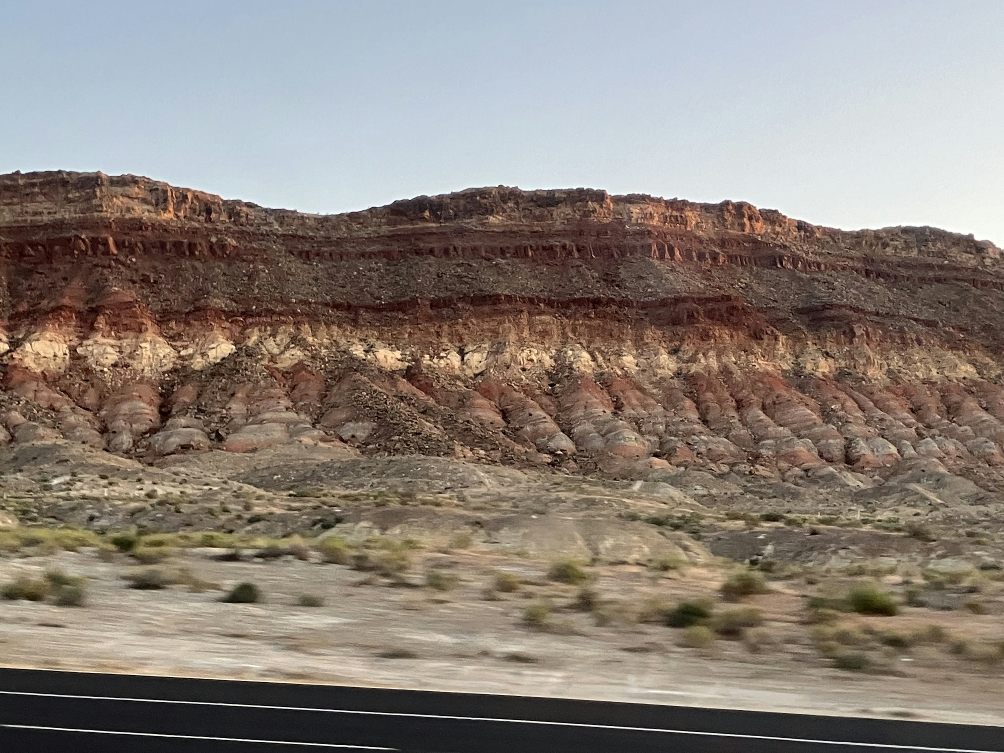 a view of a mountain from a moving car
