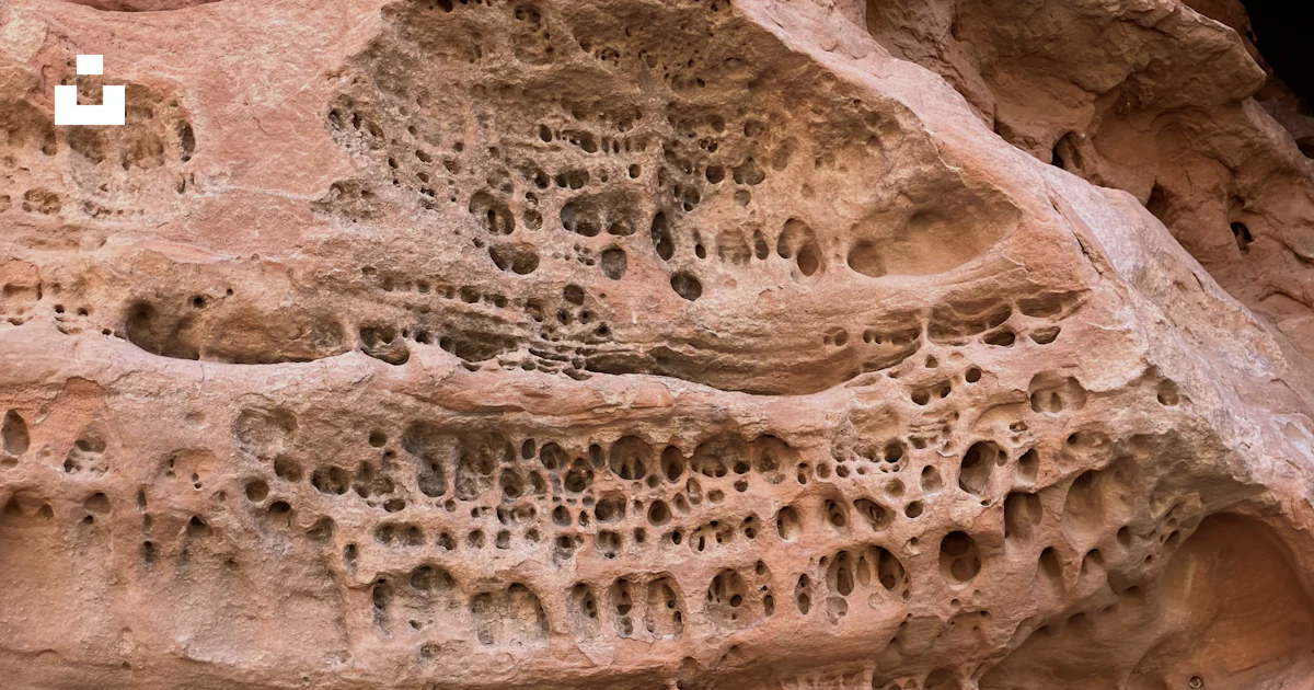 Rusty Rocks With Holes A close up of a rock formation with holes in it photo – Free Snow ...