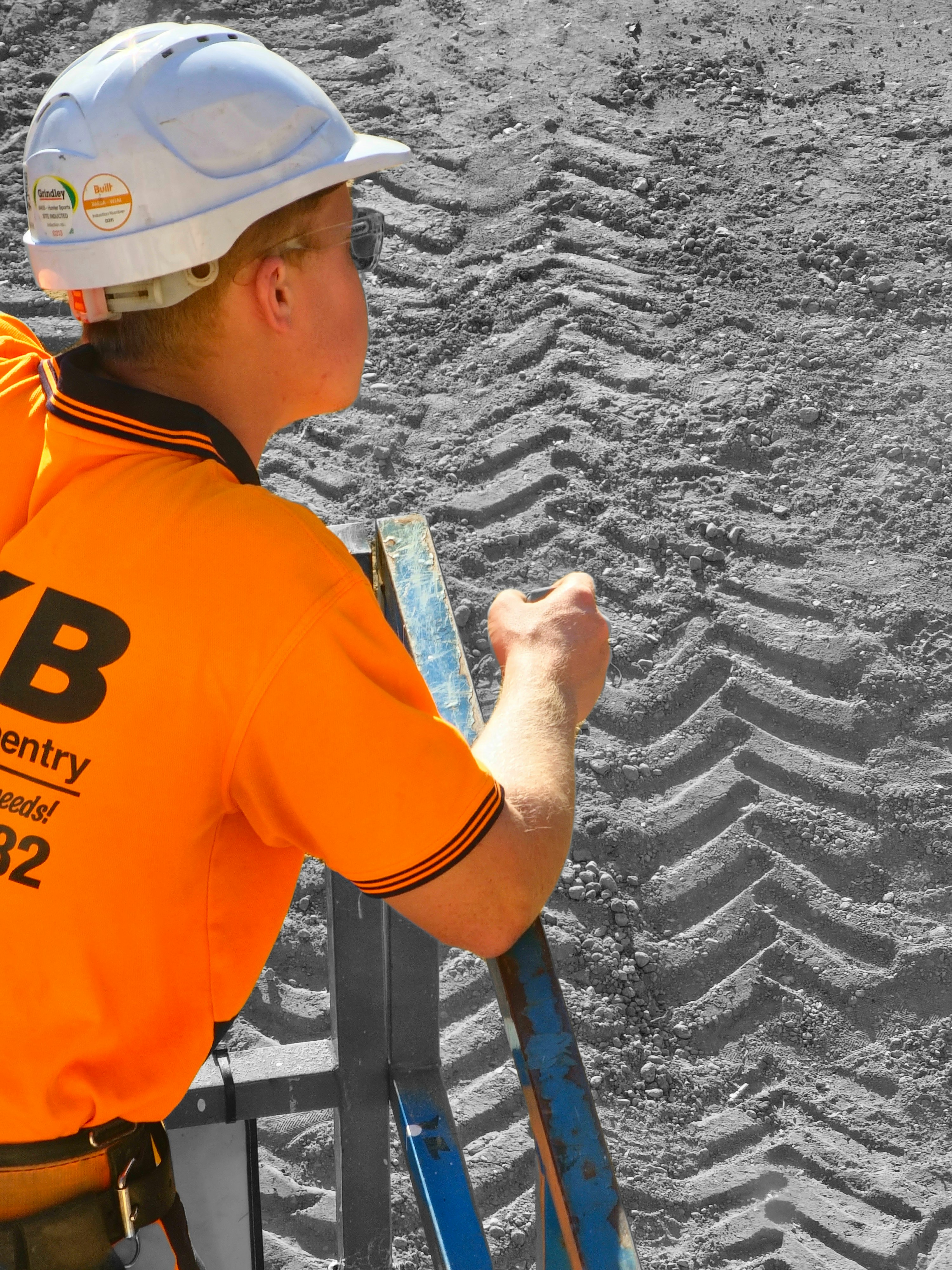 a man in an orange shirt holding a pair of skis