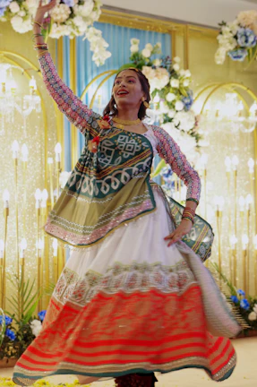 a woman in a colorful dress is dancing