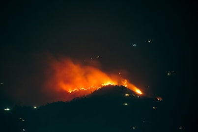 a large fire is burning in the night sky
