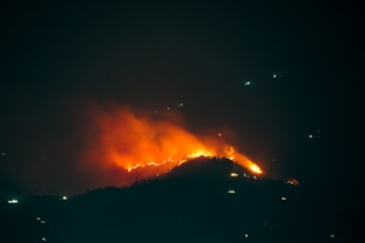 a large fire is burning in the night sky