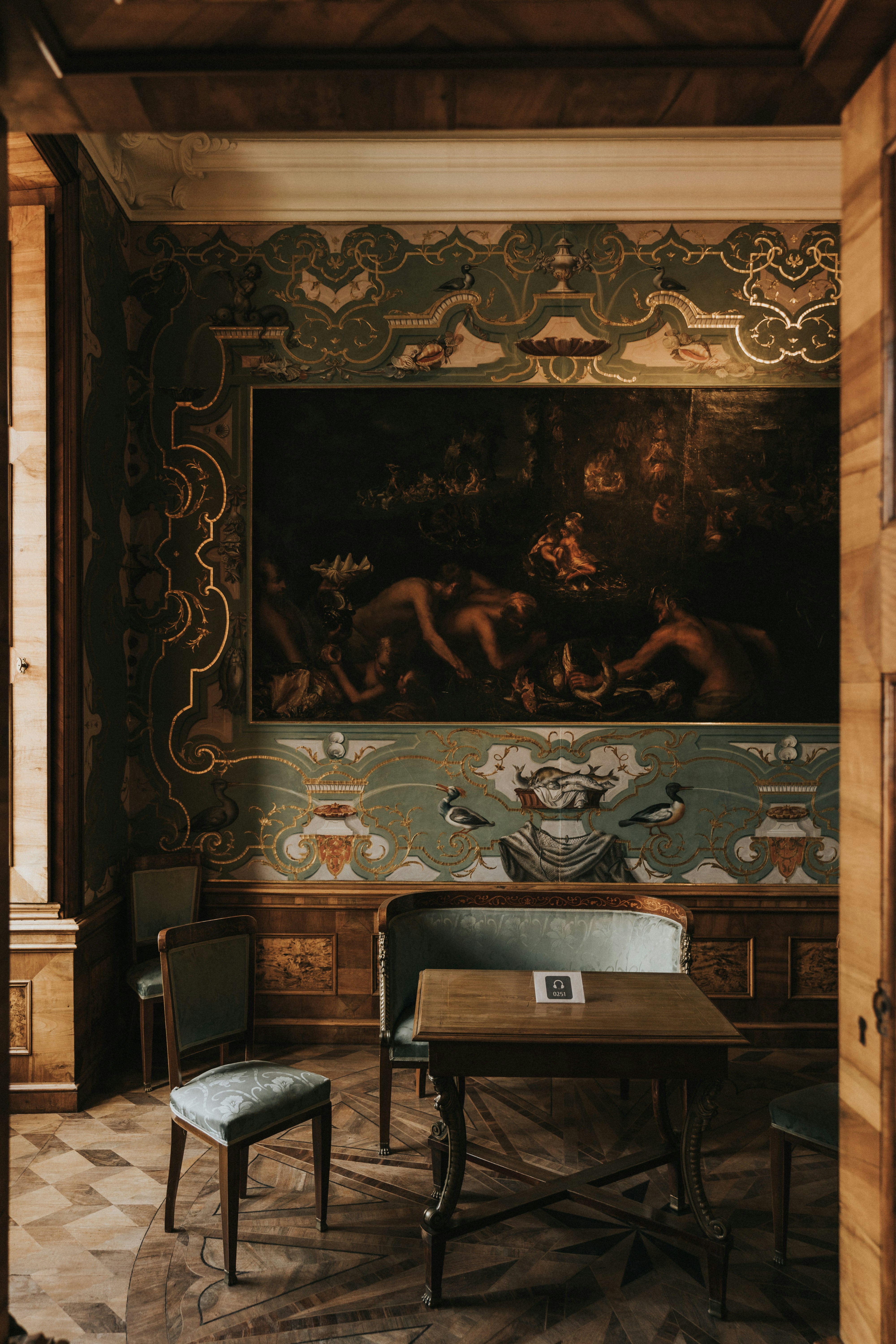 a dining room with a painting on the wall