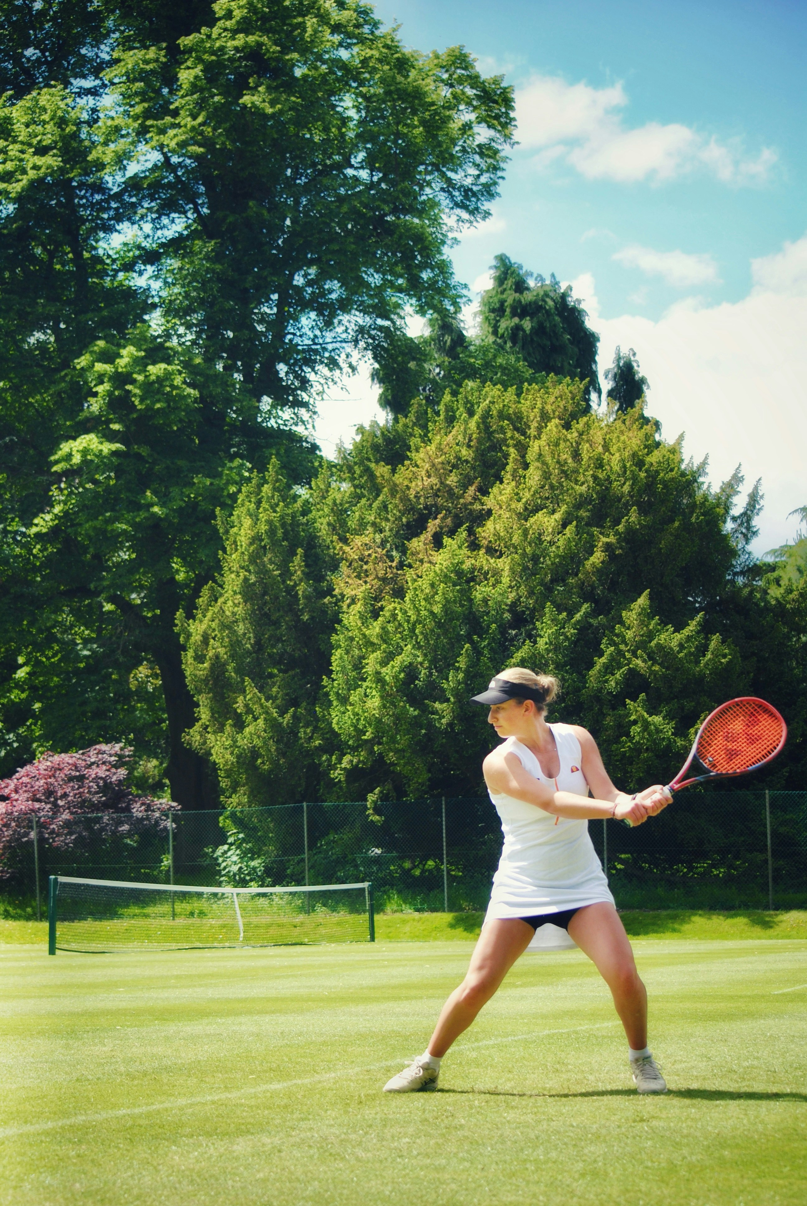 a woman holding a tennis racquet on a tennis court