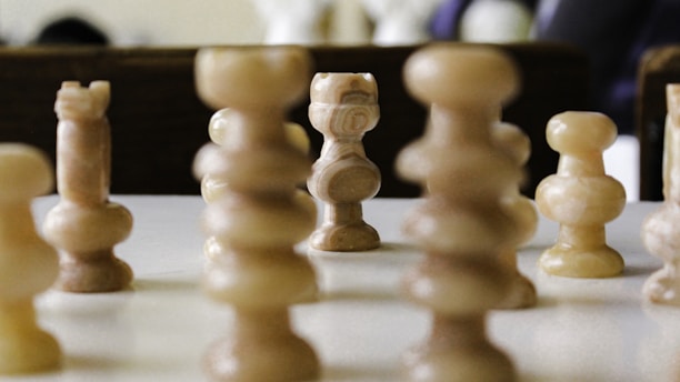 a group of chess pieces sitting on top of a table