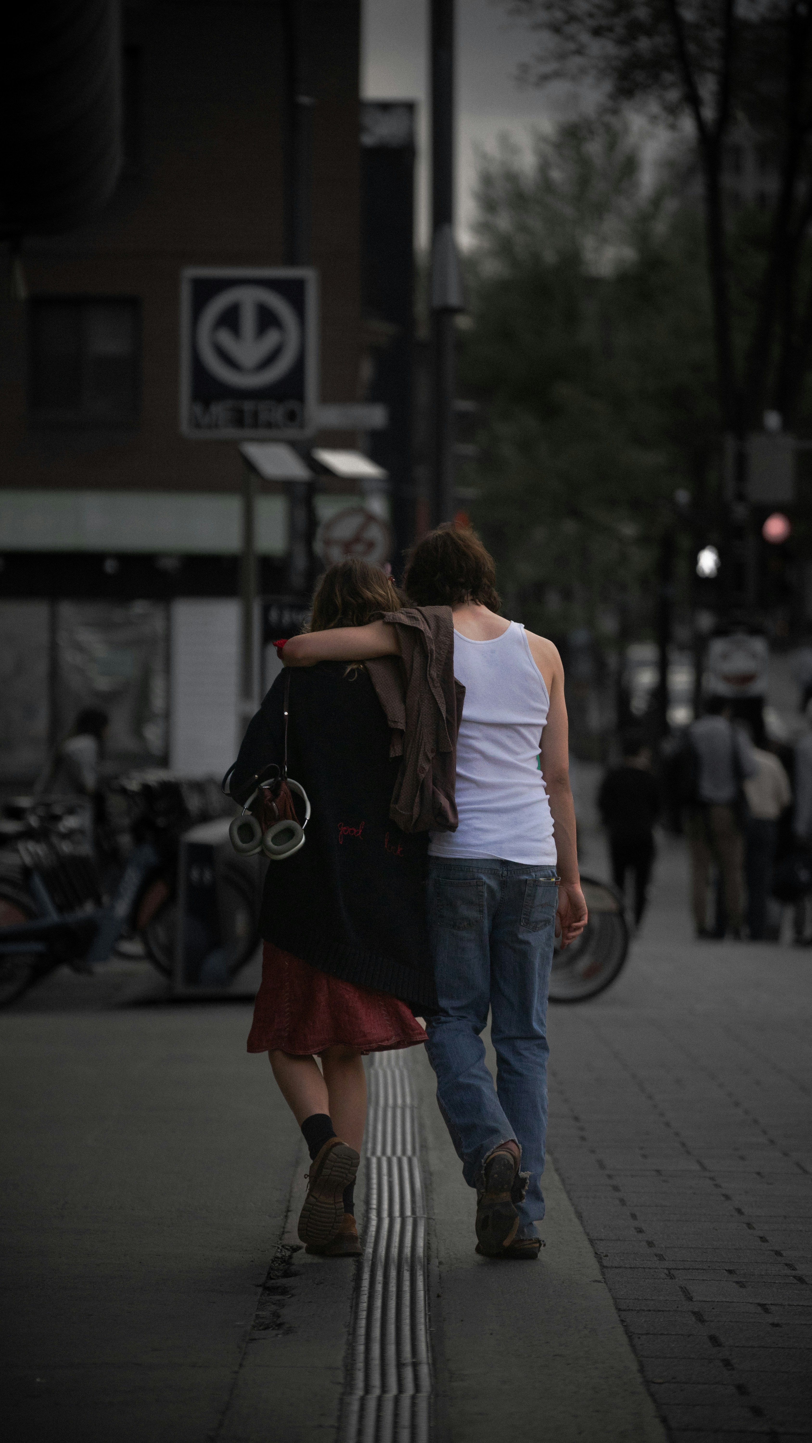 a couple of people walking down a street