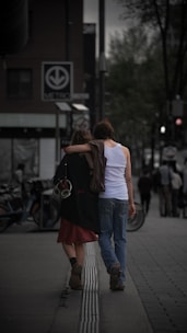 a couple of people walking down a street