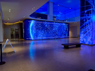 a room with a large blue wall and a bench