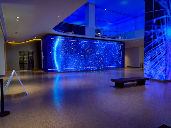 a room with a large blue wall and a bench