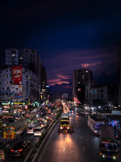 a city street filled with lots of traffic at night