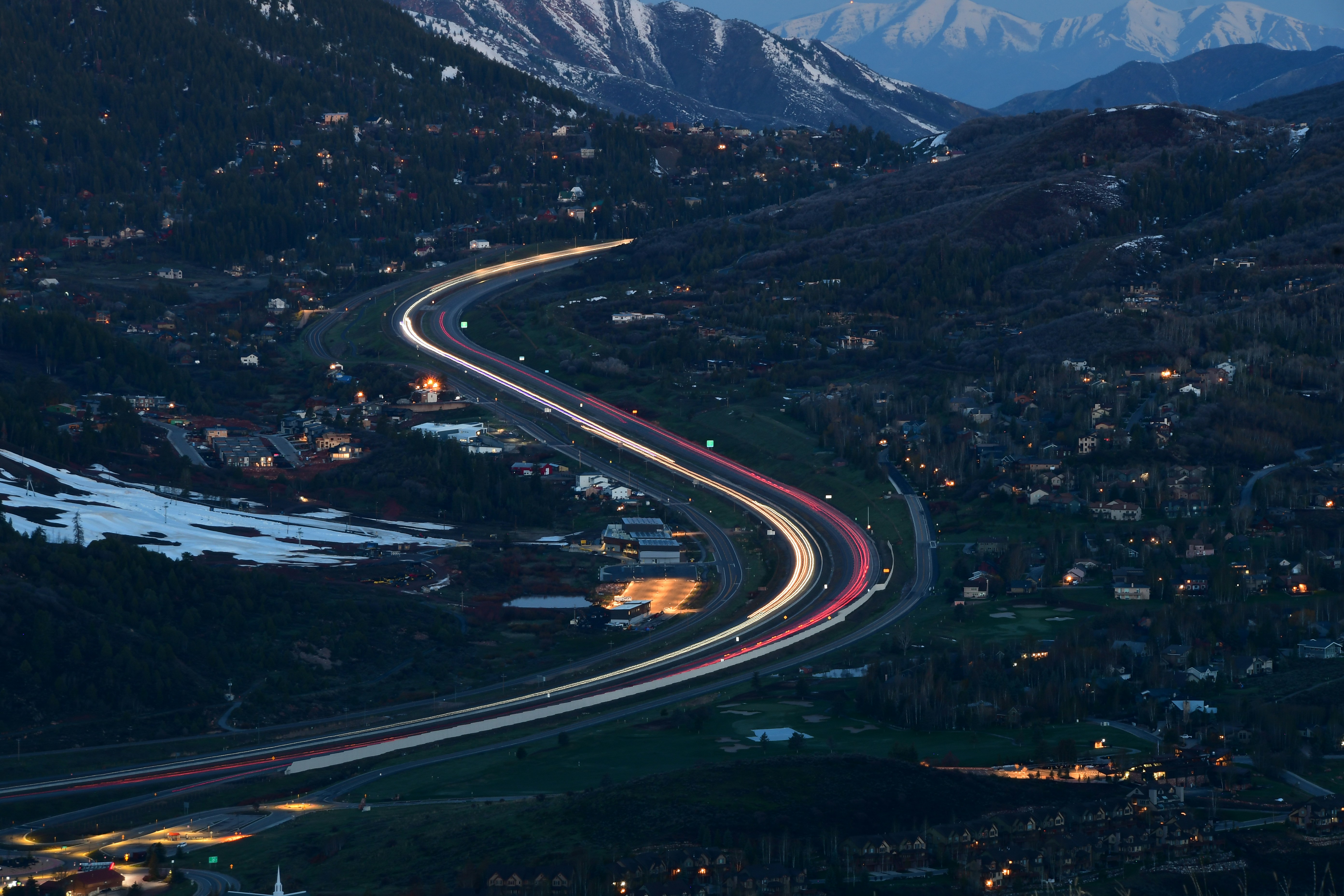 an aerial view of a highway in the mountains