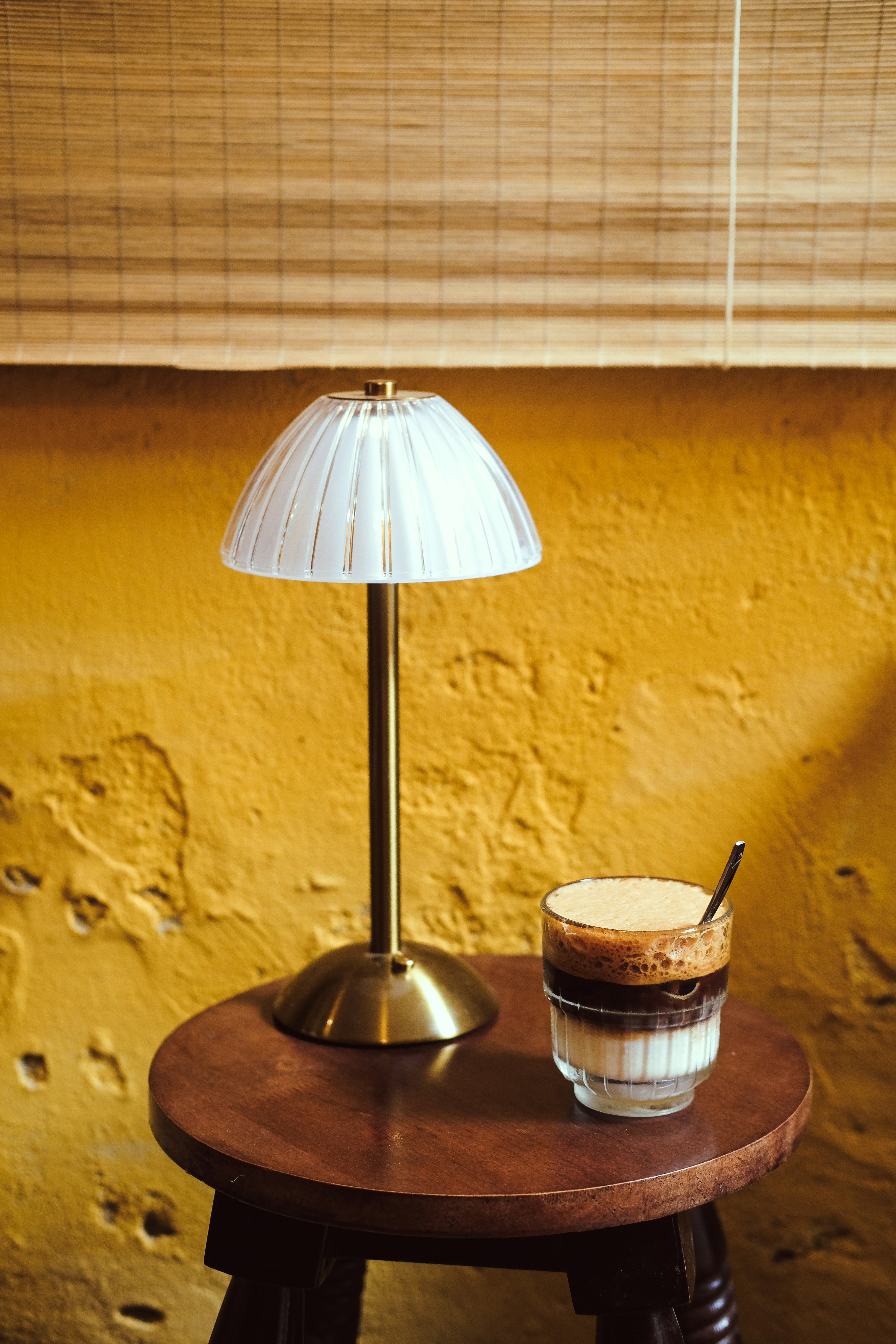 Image of a cozy coffee corner with a lamp and plant