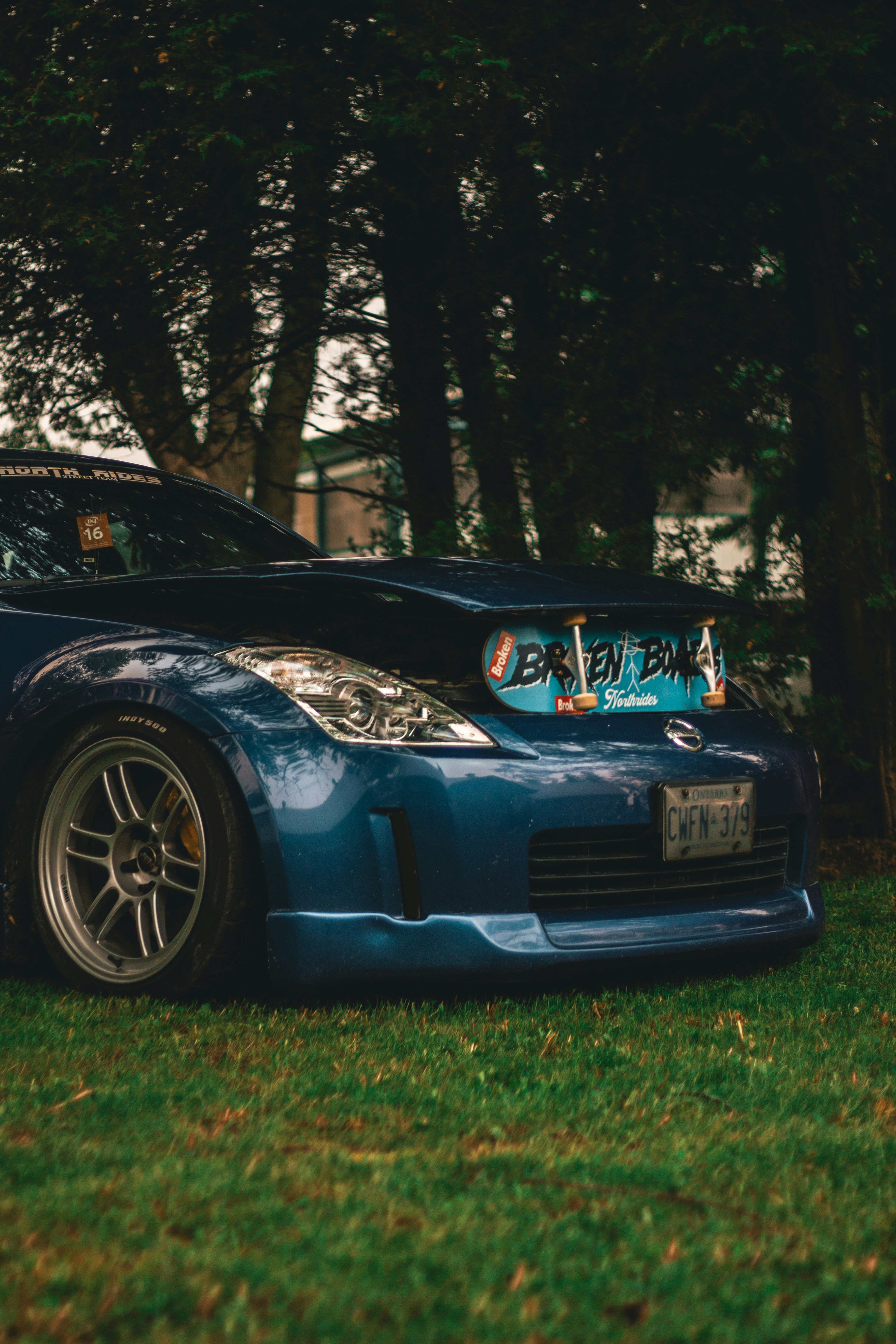 A blue sports car parked in the grass photo – Free Nissan 350z Image on ...