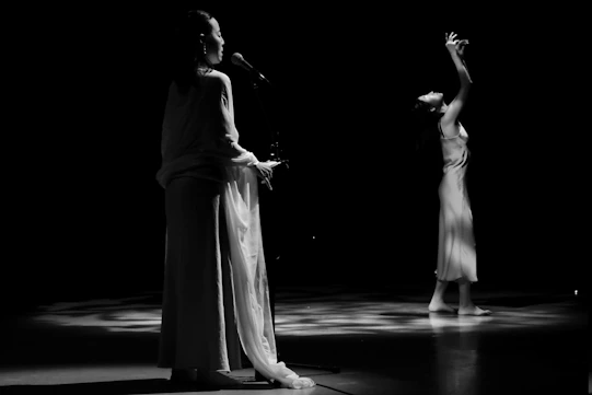 a couple of women standing on top of a stage