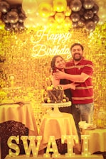 a man and a woman standing in front of a cake