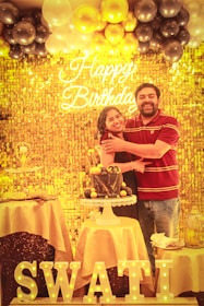 a man and a woman standing in front of a cake