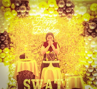 a woman sitting at a table with a cake in front of her