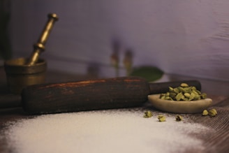 a wooden spoon filled with white powder next to a wooden scoop