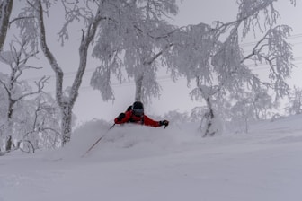 a person skiing down a snow covered hill