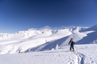 a man standing on top of a snow covered slope